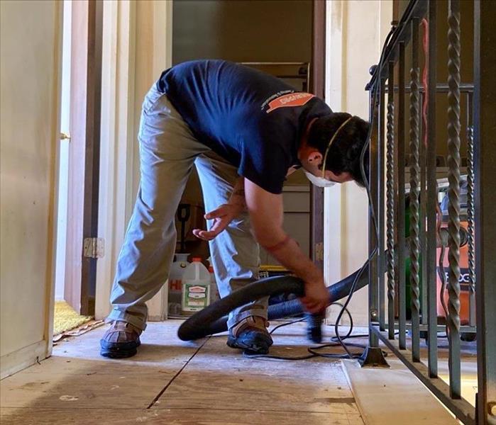 serpvro employee vacuuming debris in home